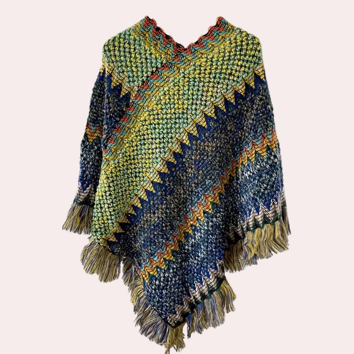 Handgemaakte kleurrijke gehaakte poncho met zigzagpatroon en franjes, perfect voor herfstmode. Uniek boho design, warme en stijlvolle dameskleding.