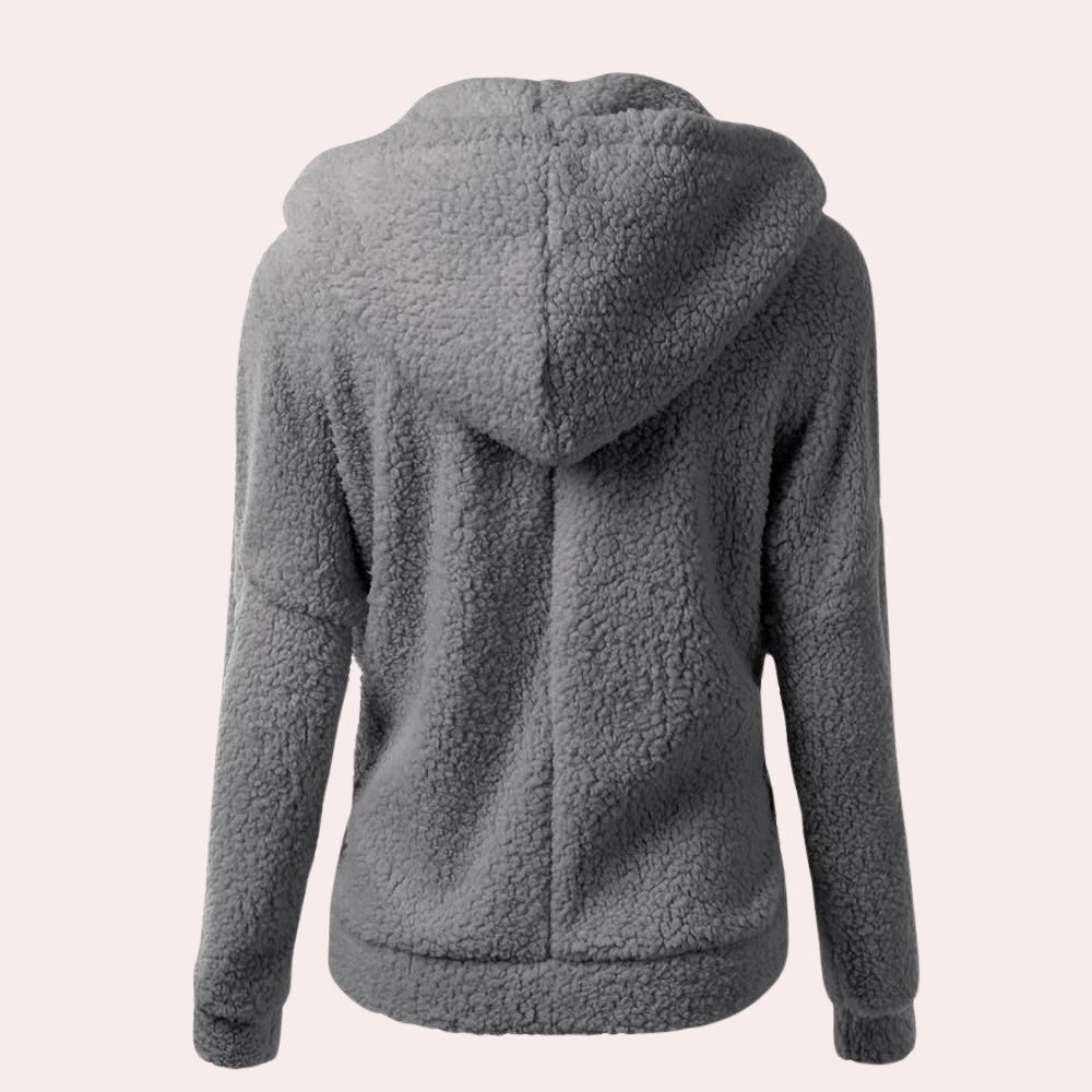 Grijze fleece hoodie voor dames, achterkant. Zachte, warme stof, ideaal voor casual winterkleding. Comfortabele pasvorm, trendy en functioneel.