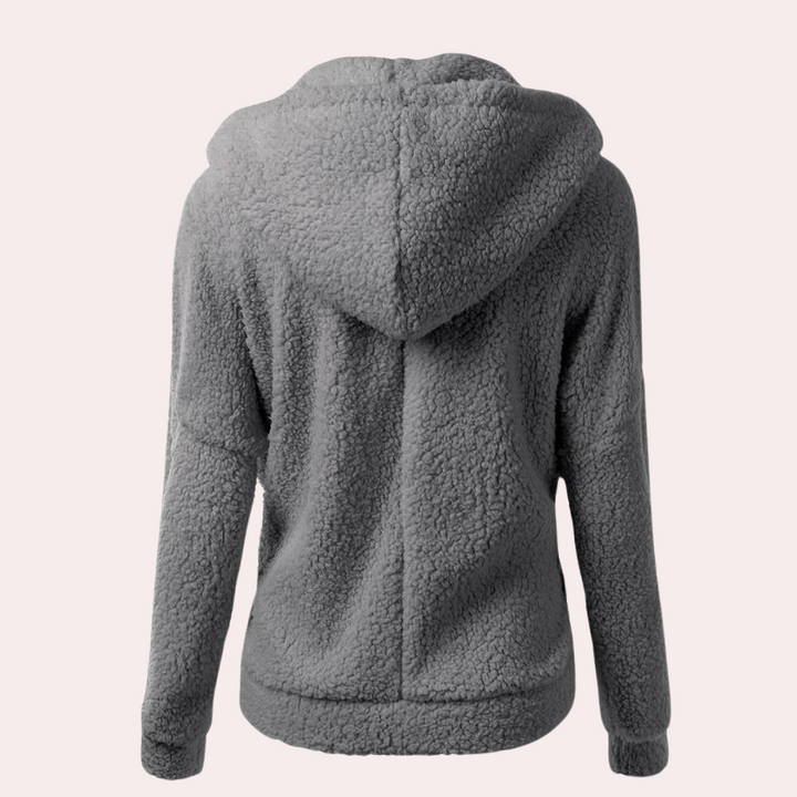 Grijze fleece hoodie voor dames, achterkant. Zachte, warme stof, ideaal voor casual winterkleding. Comfortabele pasvorm, trendy en functioneel.