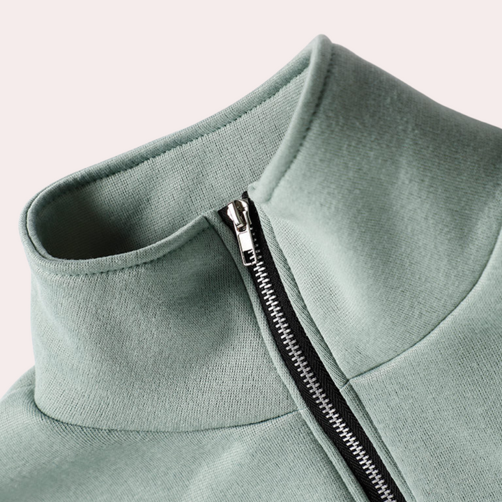Groen tweedelig joggingpak voor dames, bestaande uit een joggingbroek en een vest met halve rits