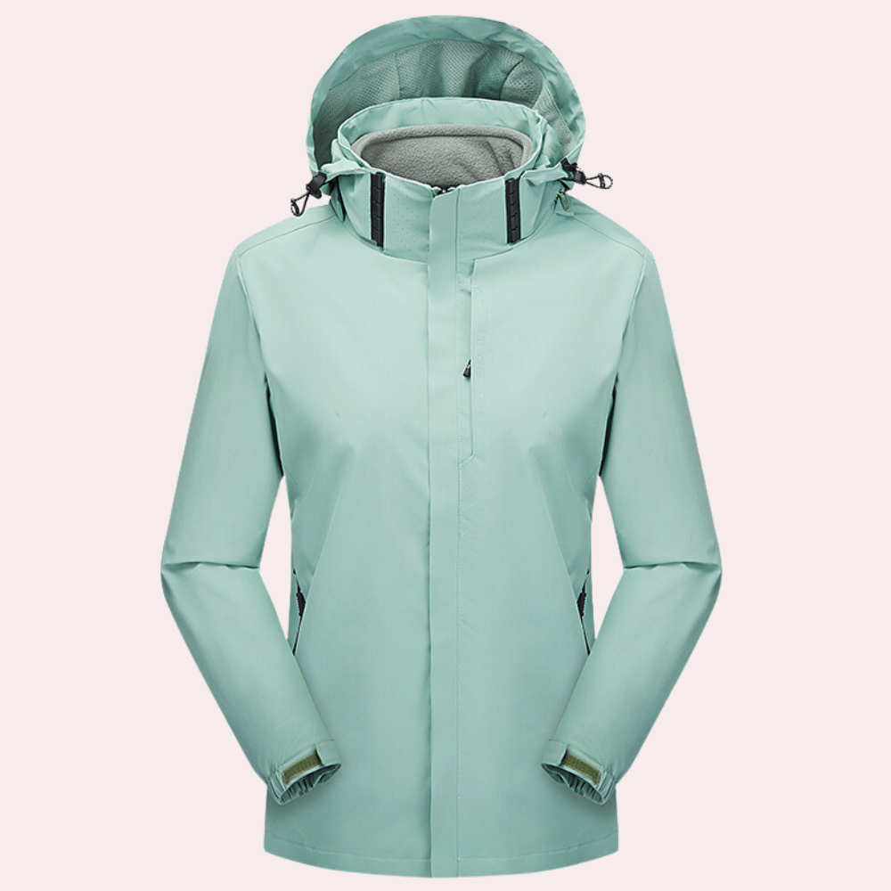Mintgroene waterdichte damesjas met capuchon, verstelbare manchetten en ritssluiting. Ideaal voor outdoor activiteiten en regenachtige dagen.