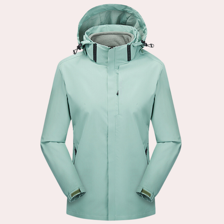 Mintgroene waterdichte damesjas met capuchon, verstelbare manchetten en ritssluiting. Ideaal voor outdoor activiteiten en regenachtige dagen.