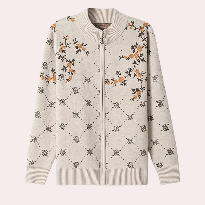 Grijze damesvest met ritssluiting, bloemenpatroon en geribbelde boorden. Perfect voor casual en stijlvolle outfits. Comfortabel en modieus design.