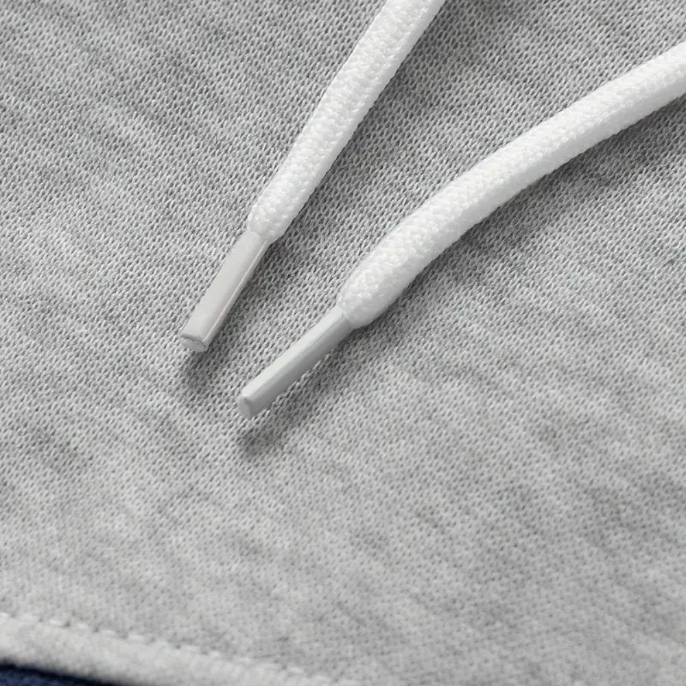 Grijze heren hoodie met capuchon, close-up van trekkoorden. Comfortabele en stijlvolle sweater, ideaal voor casual en sportieve outfits.