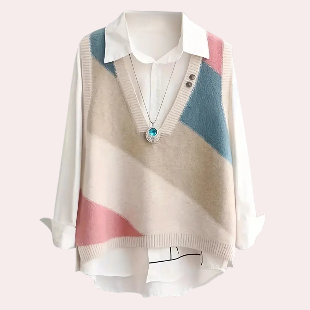 Damestrui met geometrisch patroon, V-hals en lange mouwen, in pastelkleuren roze, blauw en beige, over een witte blouse. Perfect voor casual mode.
