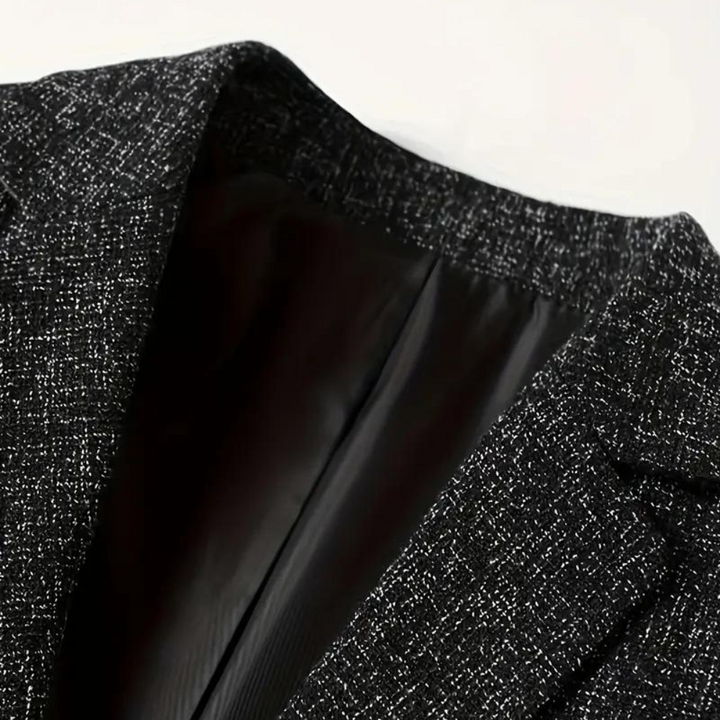 Zwarte wollen blazer met textuur, close-up van de kraag en voering. Stijlvolle herenmode, geschikt voor zakelijke en formele gelegenheden.