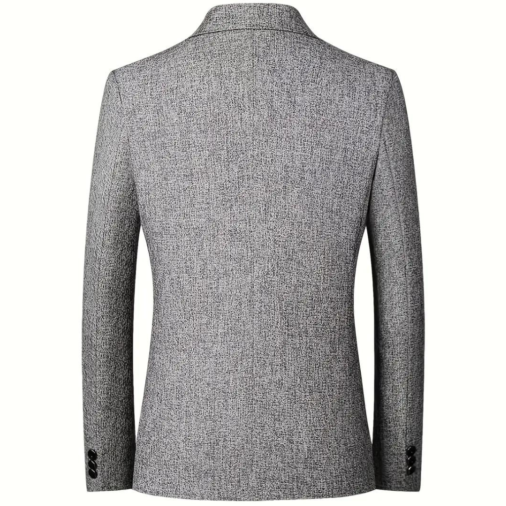 Grijze herenblazer, achterkant, met fijn geweven textuur, klassieke snit, lange mouwen, knoopdetails, geschikt voor formele en zakelijke gelegenheden.