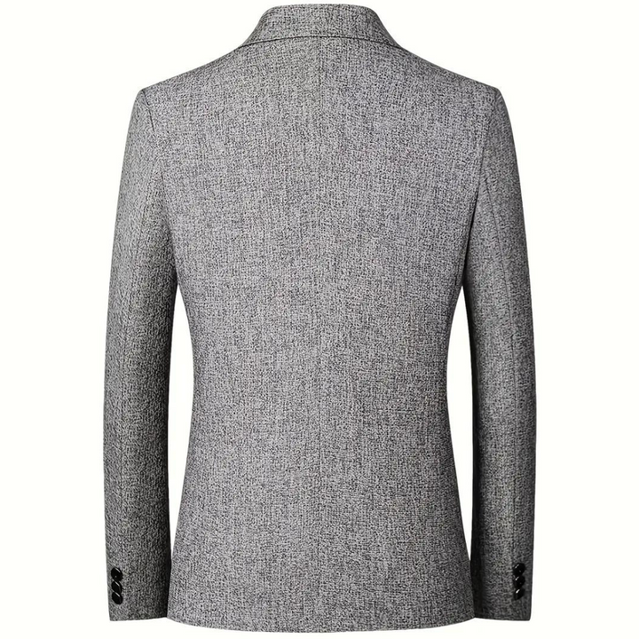 Grijze herenblazer, achterkant, met fijn geweven textuur, klassieke snit, lange mouwen, knoopdetails, geschikt voor formele en zakelijke gelegenheden.