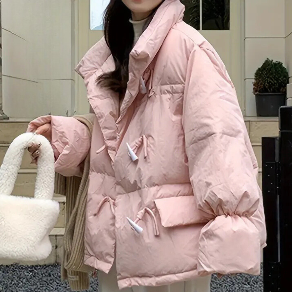 Roze oversized gewatteerde jas met grote kraag en zakken, gedragen door een persoon. Modieuze winterjas, trendy dameskleding, warme buitenkleding.