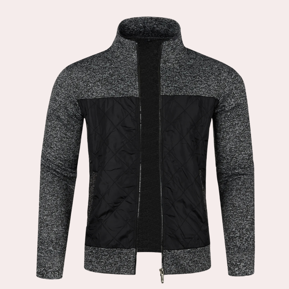 Grijze herenjas met ritssluiting, gebreide mouwen en gewatteerd zwart voorpaneel. Stijlvolle winterjas, ideaal voor casual en formele gelegenheden.