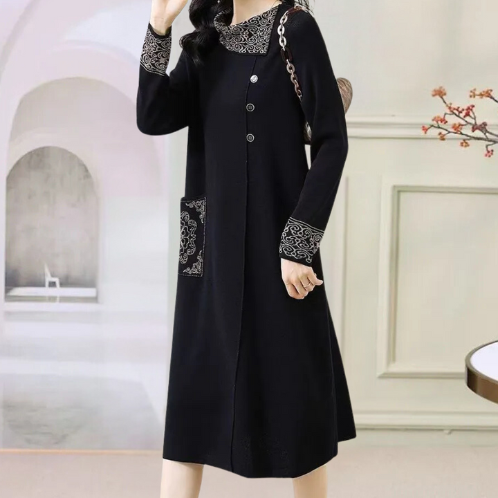 Elegante zwarte damesjurk met lange mouwen, knoopsluiting en sierlijke details op kraag en mouwen, perfect voor herfstmode en casual chic outfits.