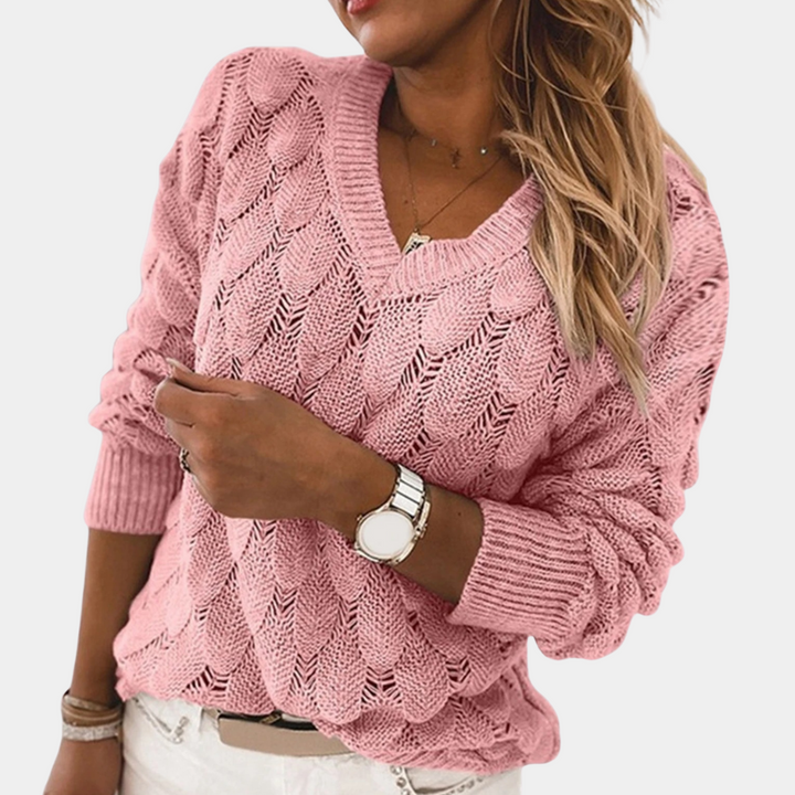 Roze gebreide damestrui met V-hals, lange mouwen en kabelpatroon. Perfect voor casual en stijlvolle outfits. Comfortabele en modieuze dameskleding.