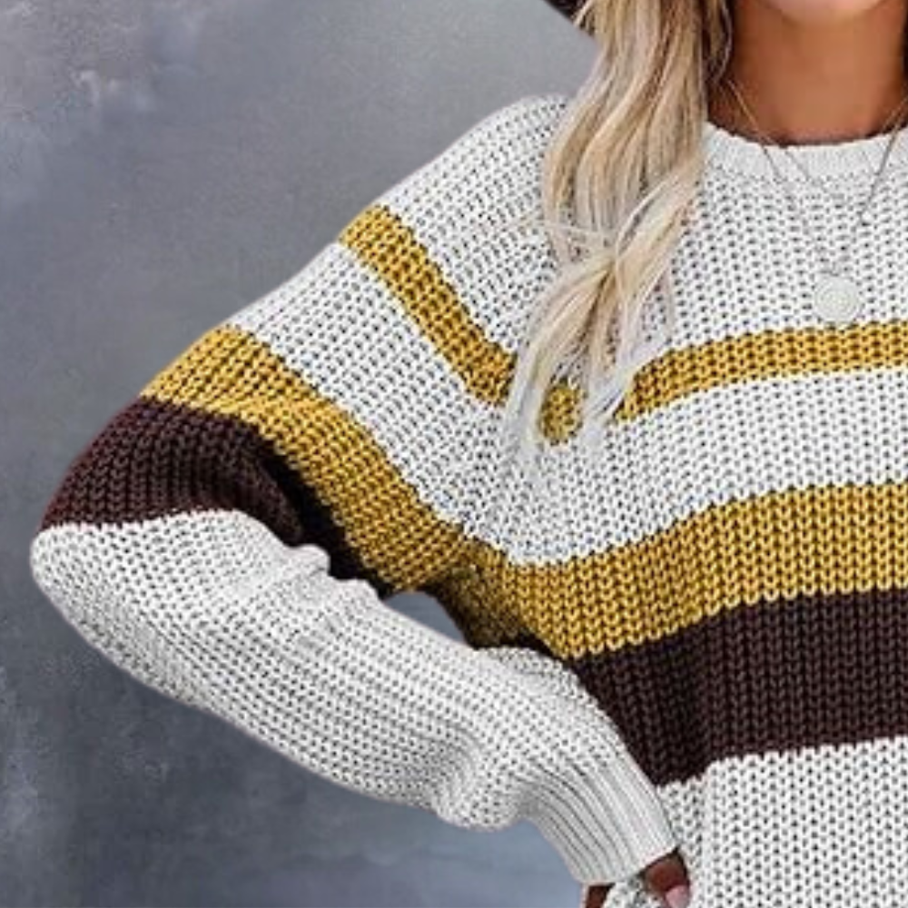 Gestreepte damestrui in wit, geel en bruin, gedragen door een vrouw. Modieuze gebreide trui, herfstkleding, casual stijl.