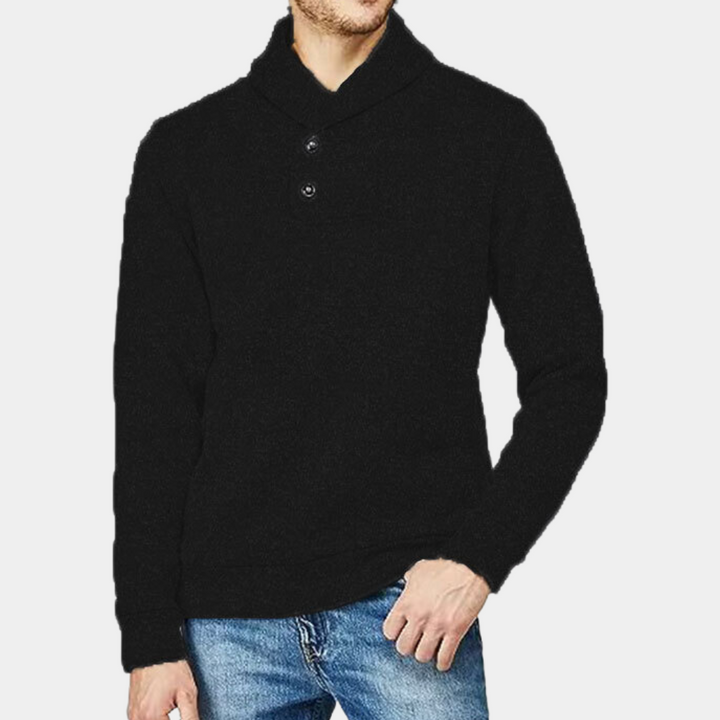 Zwarte herentrui met sjaalkraag en knopen, gecombineerd met blauwe jeans. Stijlvolle wintermode, casual outfit voor heren.