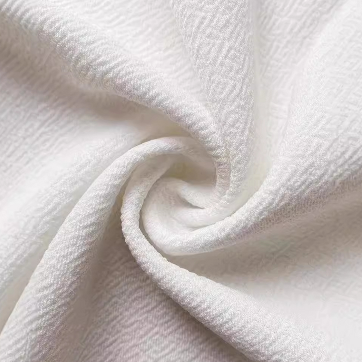 Witte textuurstof met gedetailleerd patroon, close-up. Ideaal voor interieurontwerp, mode en ambachtelijke projecten. Hoogwaardige textielmaterialen.
