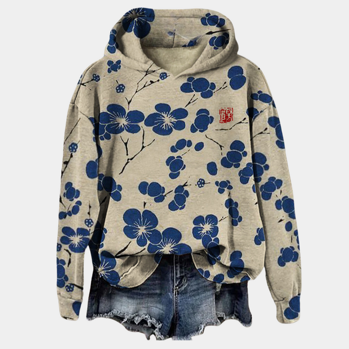 Beige hoodie met blauwe bloemenprint, capuchon en casual stijl. Perfect voor damesmode, streetwear en comfortabele outfits.