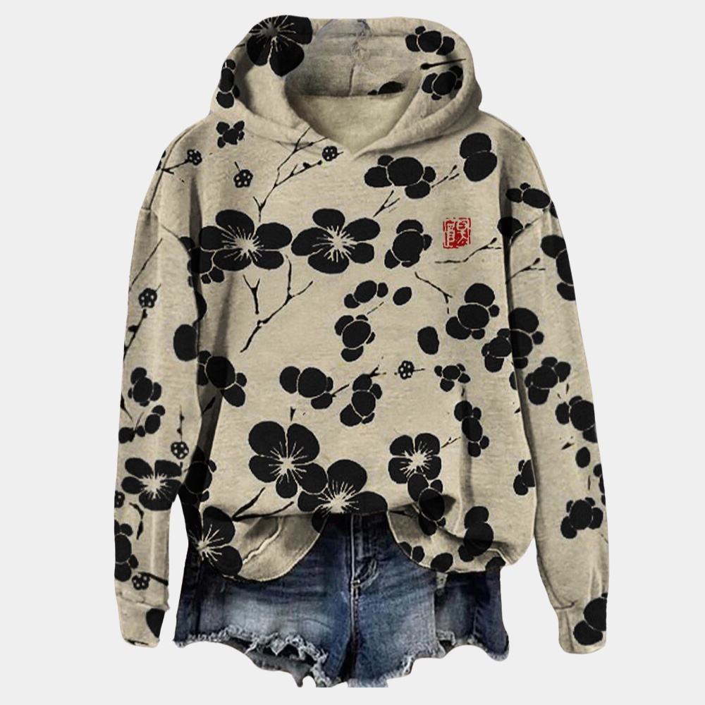 Beige hoodie met zwarte bloemenprint, capuchon en casual stijl. Perfect voor damesmode, streetwear en comfortabele outfits.