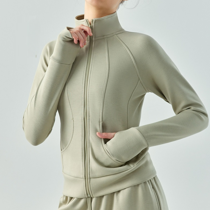 Dames sportvest met ritssluiting in beige, lange mouwen, hoge kraag, comfortabele pasvorm. Perfect voor yoga en fitness. Sportkleding voor dames.