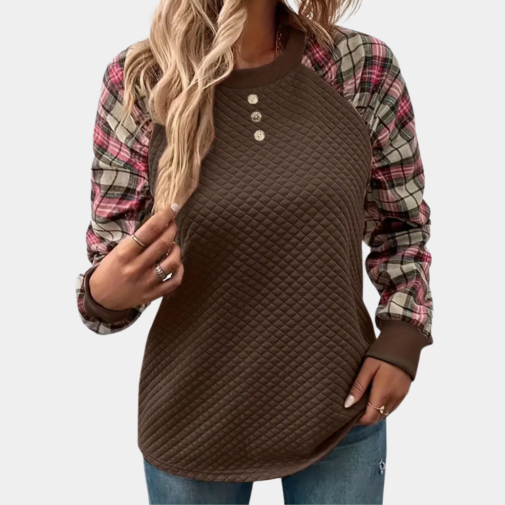 Vrouw draagt bruine gewatteerde trui met geruite mouwen, casual herfstmode, trendy dameskleding, comfortabele outfit, modieuze stijl.