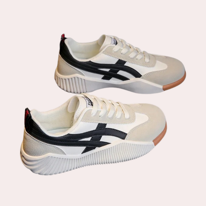 Ultracomfortabele damessneakers, wit met zwarte strepen, sportief design, ideaal voor dagelijks gebruik en wandelen. Trendy en duurzaam schoeisel.