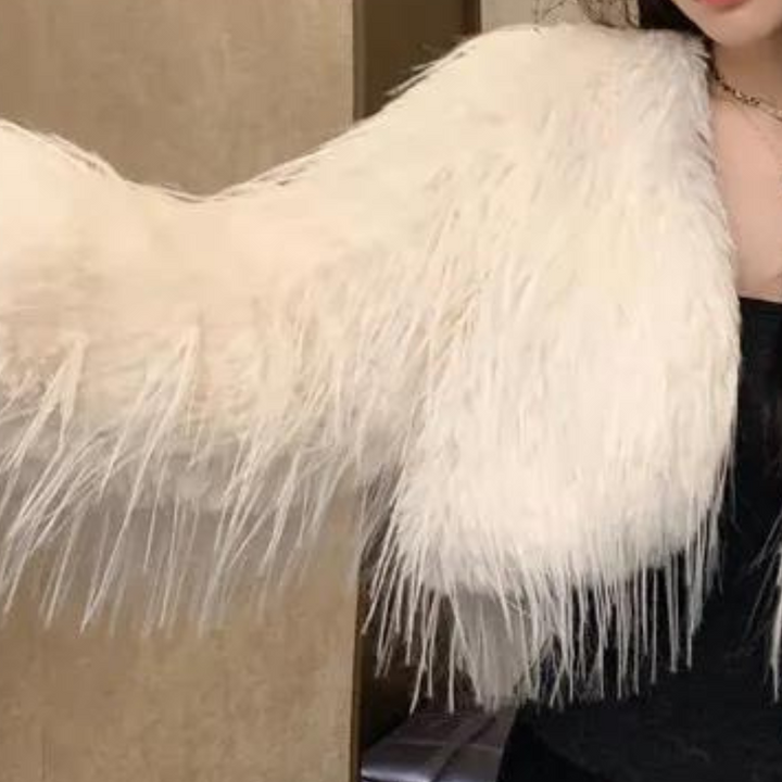 Vrouw in stijlvolle witte faux fur jas, modetrend herfst-winter, luxe en elegantie, perfect voor chique avondkleding en modebewuste outfits.