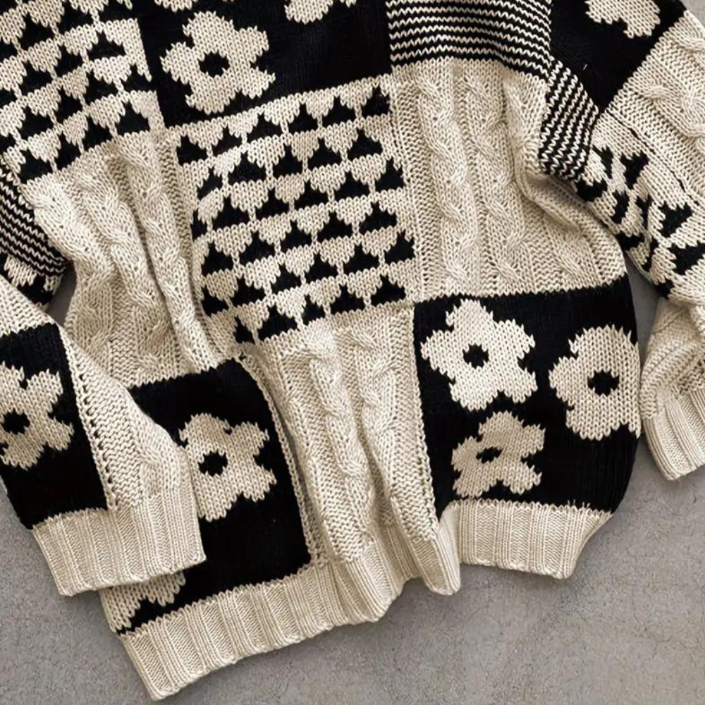 Zwart-witte gebreide trui met bloemen- en geometrisch patroon, kabelbreisel, trendy wintermode, warme dameskleding, stijlvolle herentrui.
