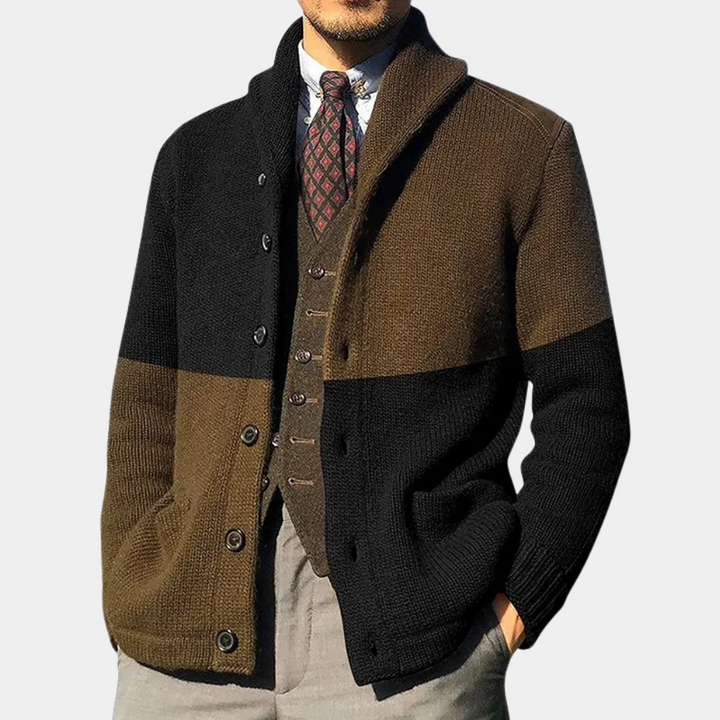 Man in stijlvolle, tweekleurige gebreide cardigan met knopen, bruine en zwarte tinten, over een geruit vest en stropdas, modieuze herenkleding.