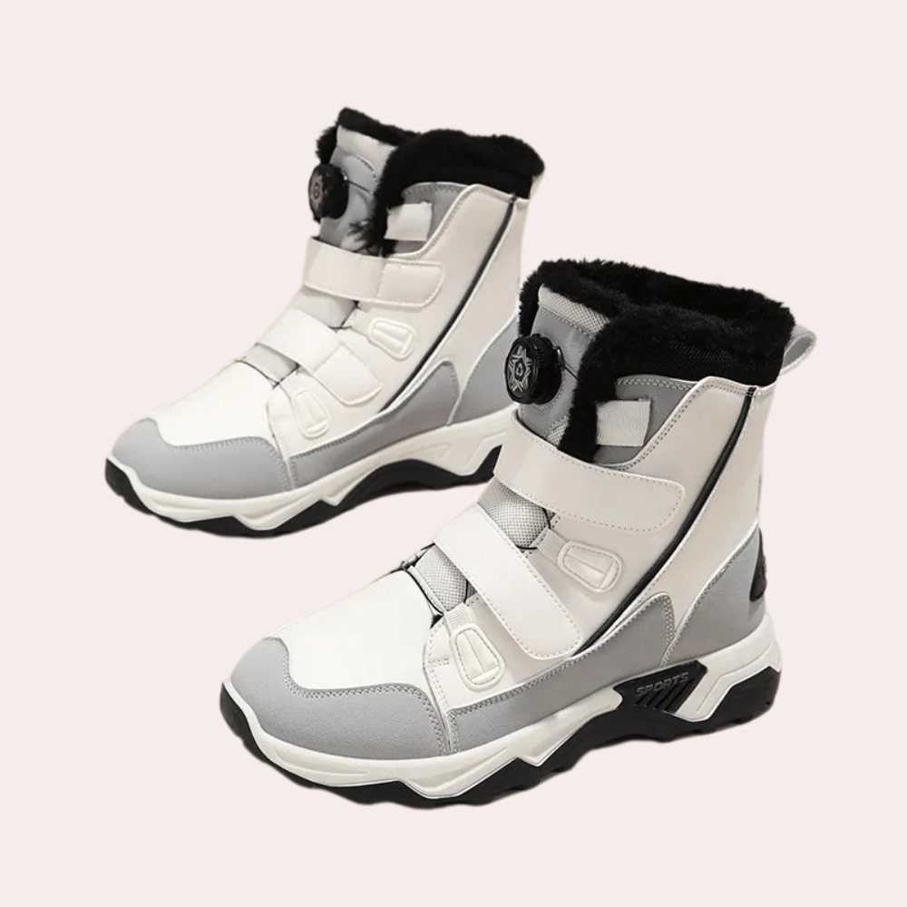 Witte en grijze winterlaarzen met klittenbandsluiting en zwarte voering, ideaal voor koude weersomstandigheden. Comfortabele en stijlvolle dameslaarzen.