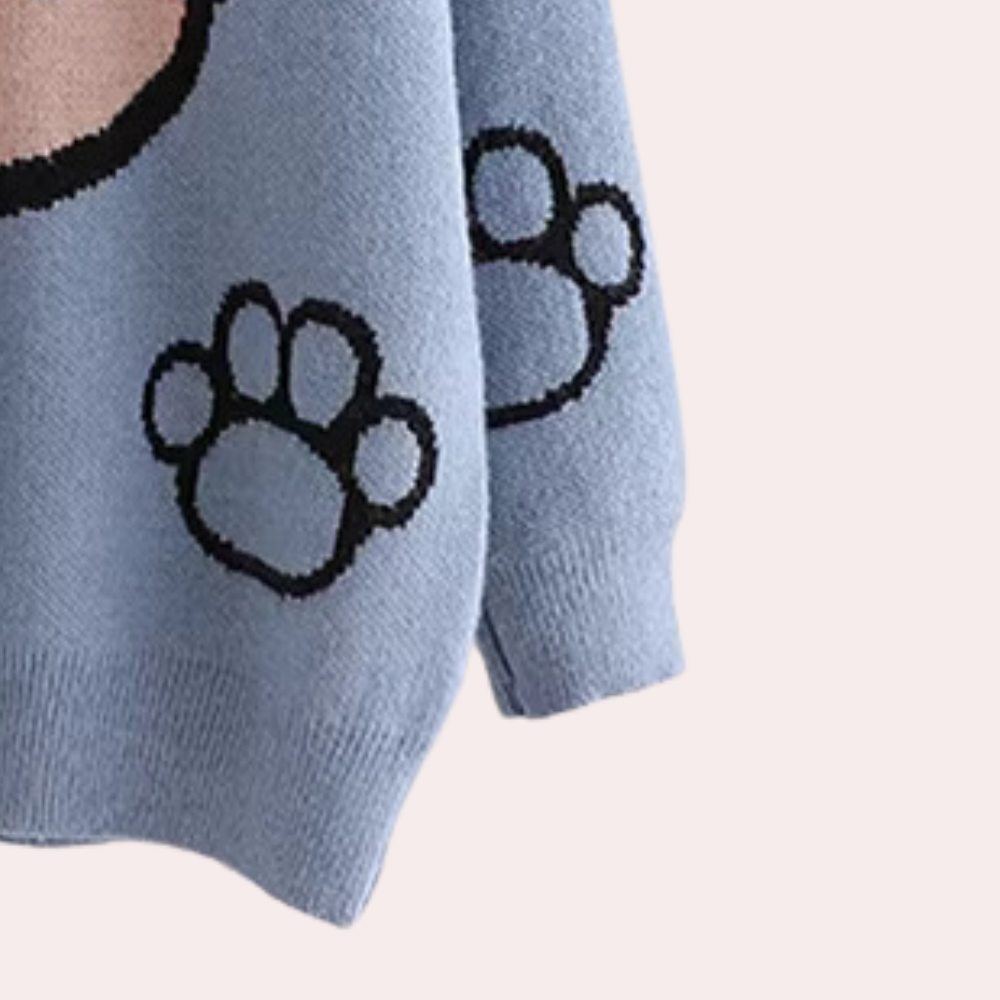 Blauwe trui met schattige zwarte pootafdrukken, ideaal voor dierenliefhebbers. Zachte stof, perfect voor casual en comfortabele outfits.