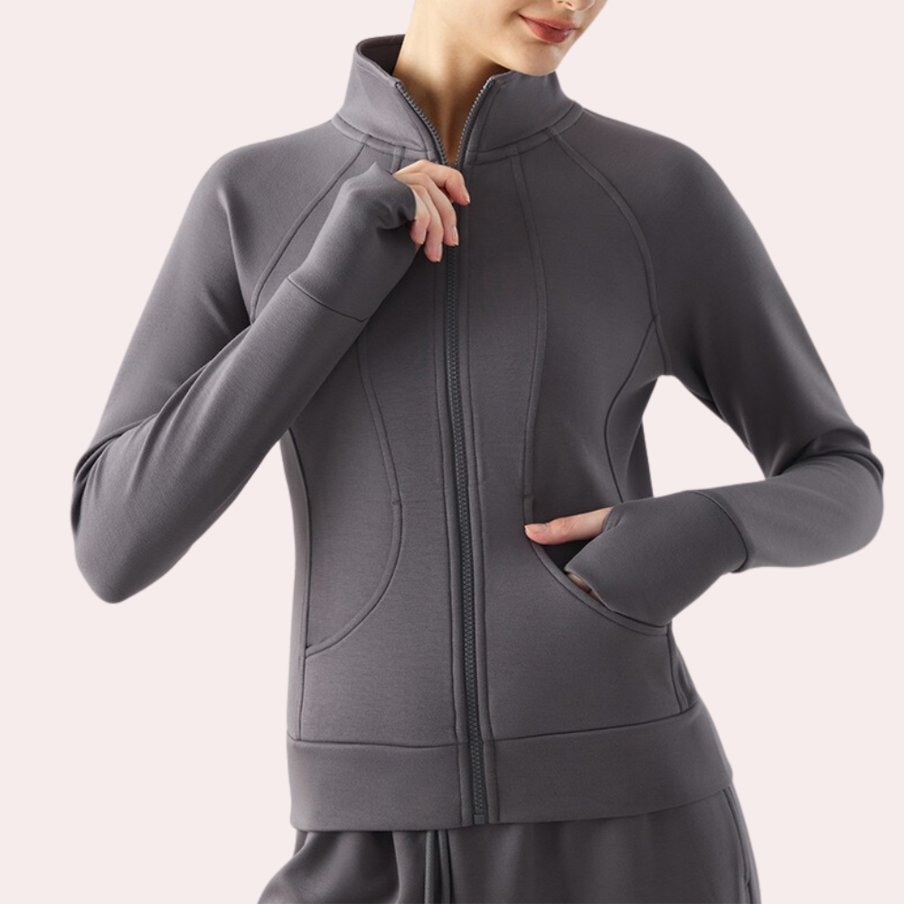 Grijze dames sportjas met ritssluiting, hoge kraag en zakken, ideaal voor fitness en casual wear. Comfortabele en stijlvolle activewear.