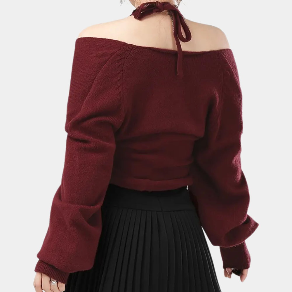 Vrouw in bordeauxrode off-shoulder trui met lange mouwen en geplooide zwarte rok, modieuze herfstkleding, trendy damesmode.