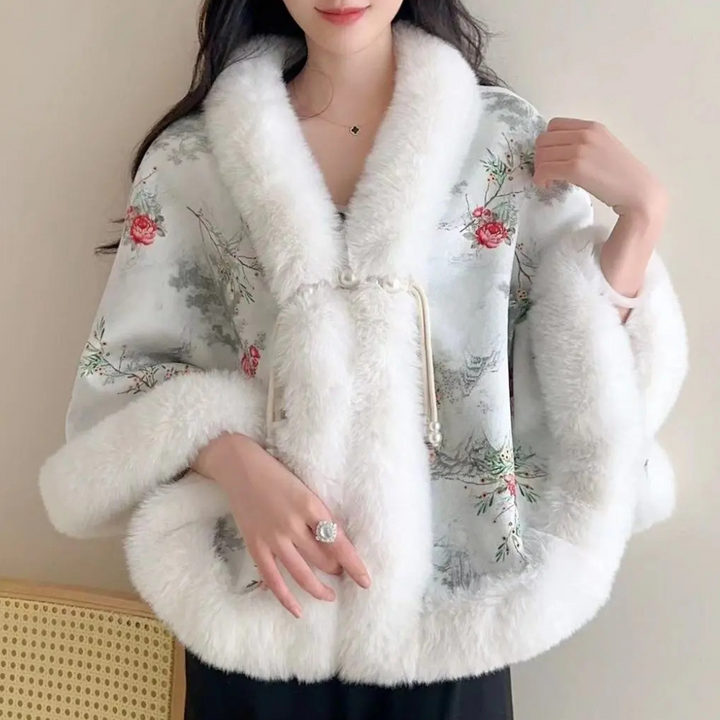 Vrouw draagt elegante kimono met bloemenprint en witte bontkraag, ideaal voor wintermode. Stijlvolle dameskleding, trendy en warm.