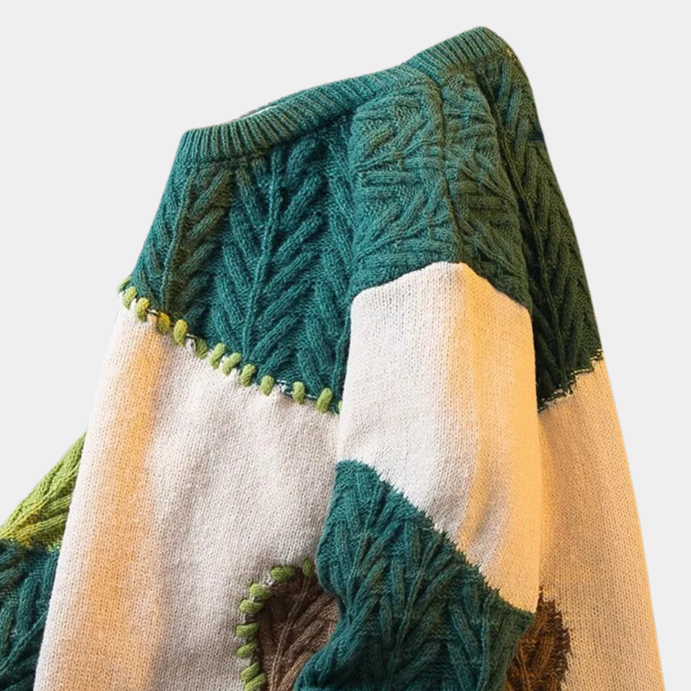 Groene en beige gebreide trui met kabelpatroon, patchwork design en ronde hals. Perfect voor herfstmode en casual winteroutfits.