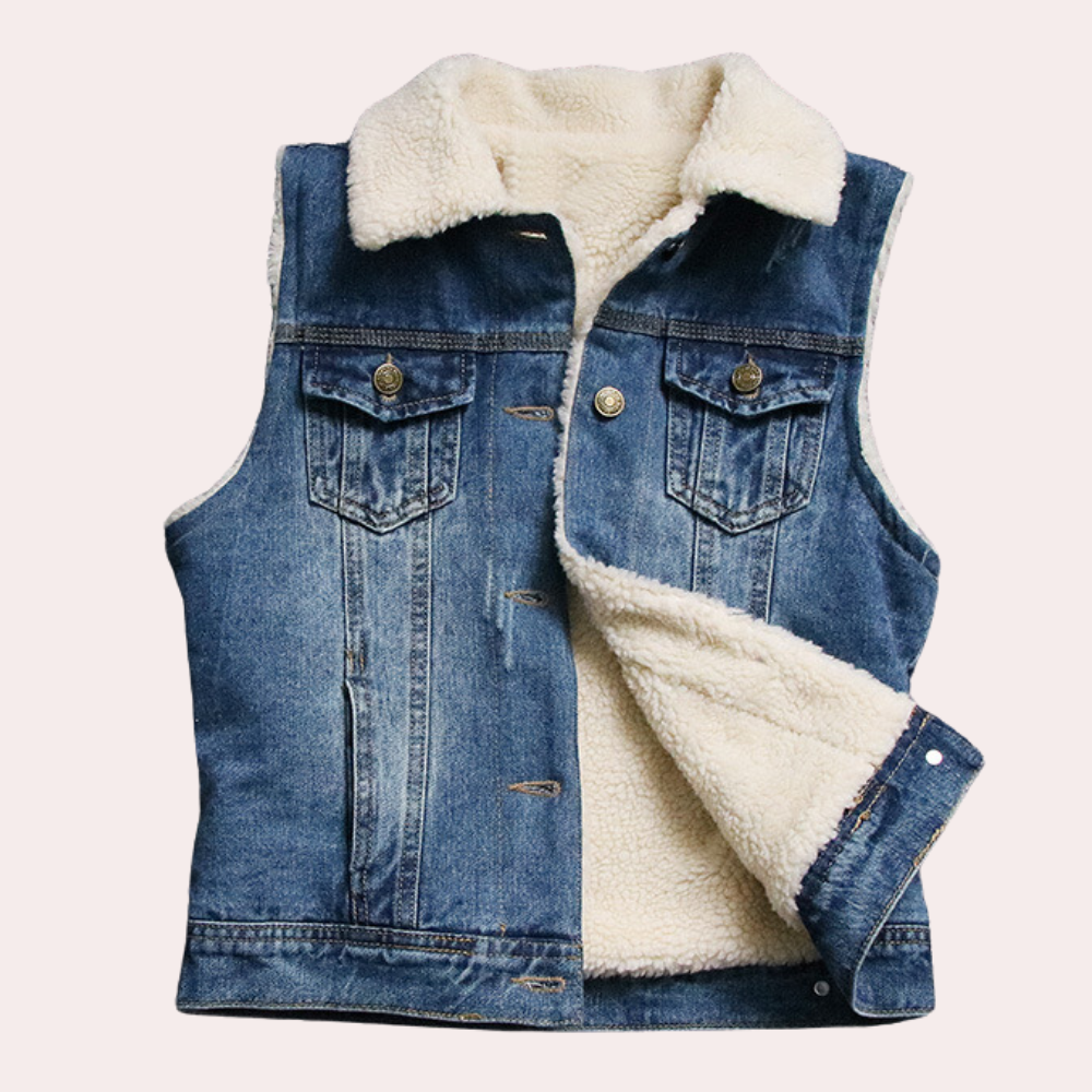Mouwloos denim jack met schapenvacht voering, knoopsluiting en borstzakken. Perfect voor herfstmode en casual outfits.