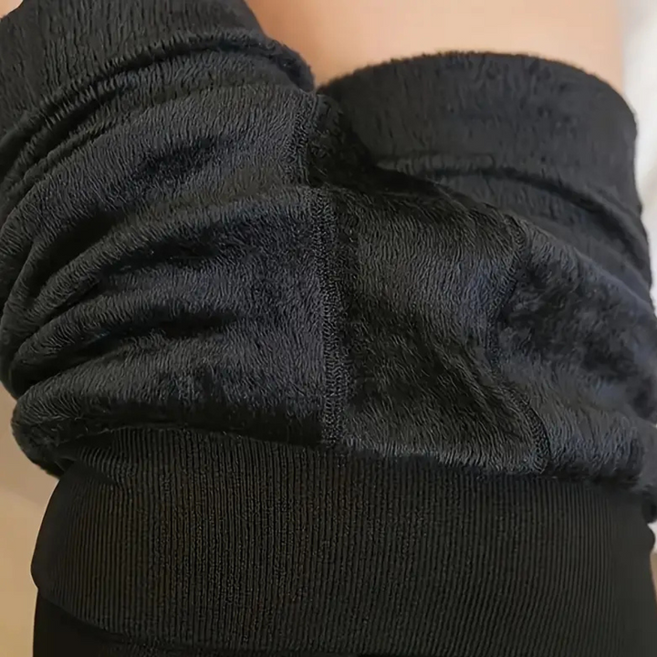 Zwarte fleece broek met geribbelde tailleband, comfortabele en warme stof, ideaal voor wintermode en casual outfits.