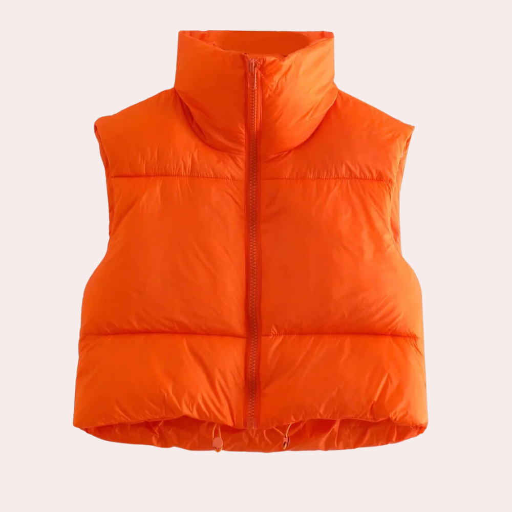 Oranje gewatteerd dames bodywarmer met hoge kraag en ritssluiting, ideaal voor herfst- en wintermode. Comfortabele en stijlvolle outdoor kleding.