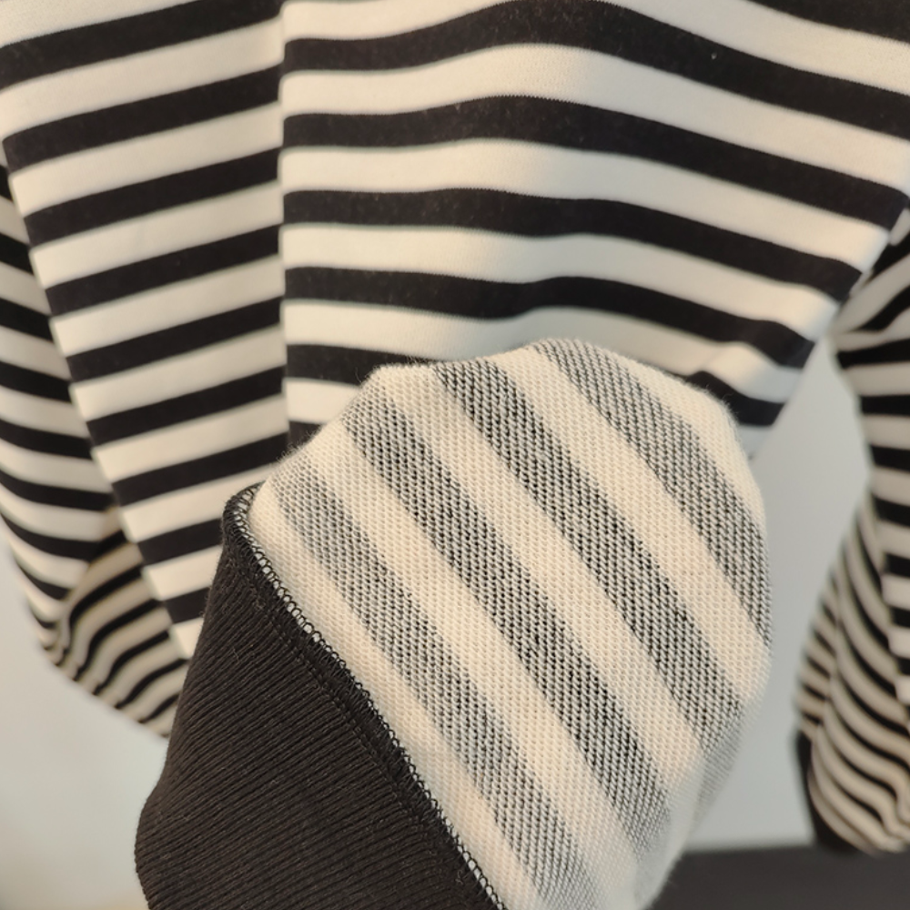Zwart-wit gestreepte trui met close-up van mouw, katoenmix, casual mode, uniseks kleding, moderne stijl, comfortabele pasvorm.