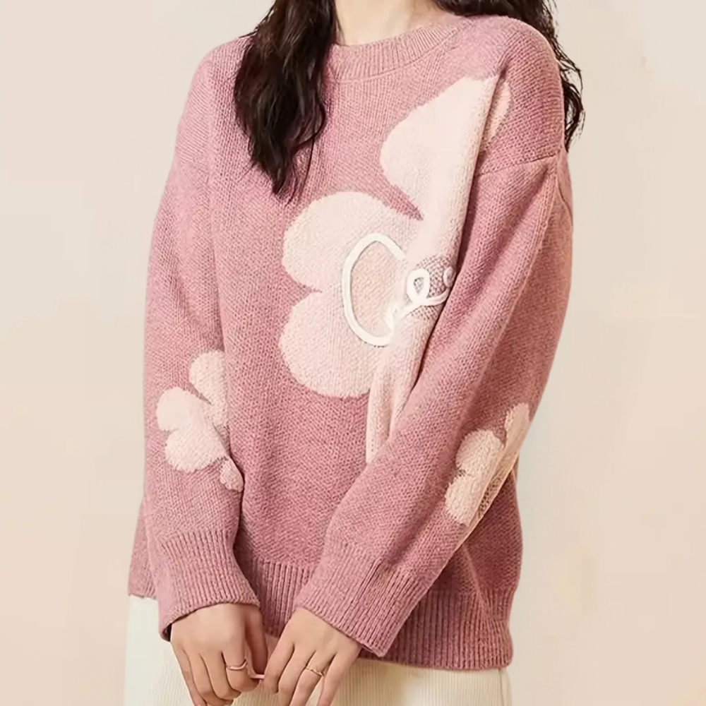 Roze damestrui met grote bloemenprint, lange mouwen en ronde hals. Modieuze gebreide trui, ideaal voor casual herfst- en winteroutfits.