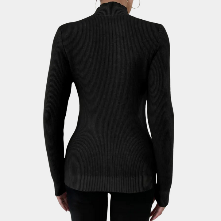 Zwarte ribgebreide damestrui met lange mouwen, getailleerd ontwerp, gezien van achteren. Perfect voor herfst- en wintermode.