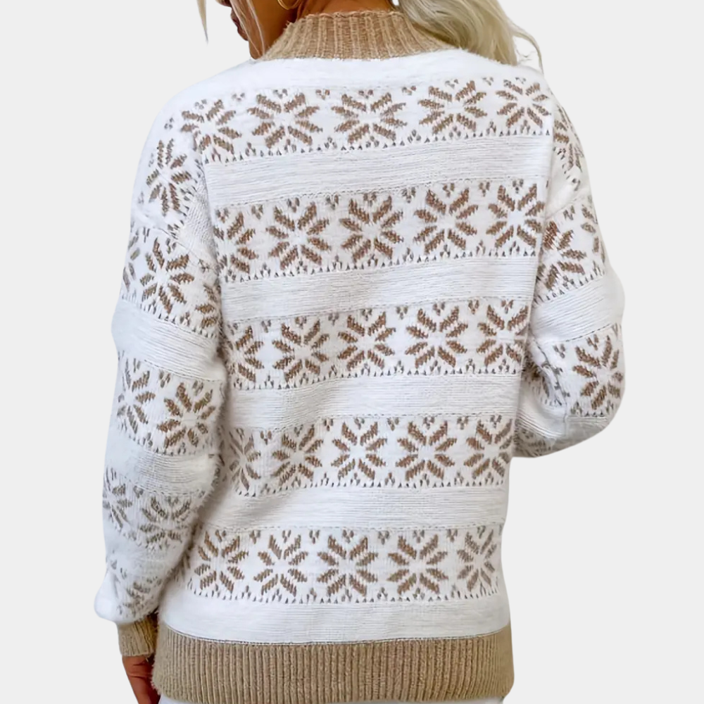 Witte gebreide trui met beige sneeuwvlokpatroon, lange mouwen en geribbelde zoom. Perfect voor wintermode en casual outfits.