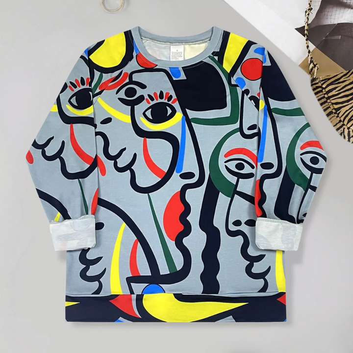 Kleurrijke trui met abstracte gezichten, moderne kunststijl, lange mouwen, unisex design, perfect voor casual mode en creatieve expressie.