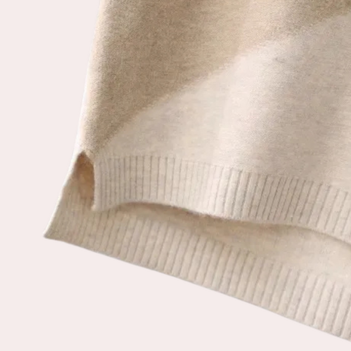 Beige wollen trui detail met ribgebreide zoom, zachte stof, comfortabele pasvorm, modieuze dameskleding, herfst- en wintermode.