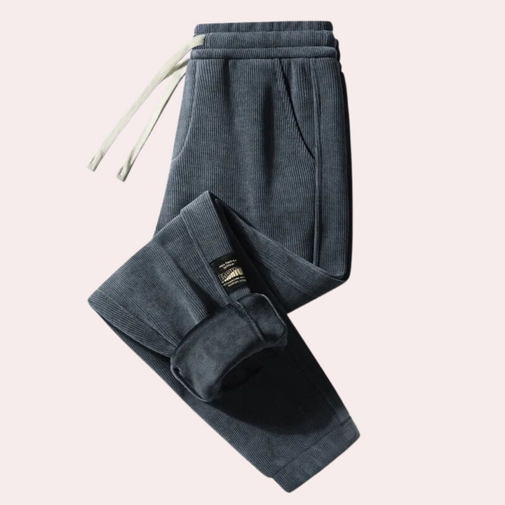 Donkerblauwe ribfluwelen joggingbroek met trekkoord, comfortabele pasvorm, casual stijl, ideaal voor dagelijks gebruik en sportieve activiteiten.