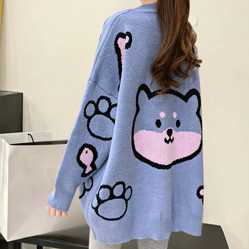 Blauwe oversized trui met schattige cartoon hond en pootafdrukken, trendy damesmode, casual winterkleding, comfortabele gebreide stof.