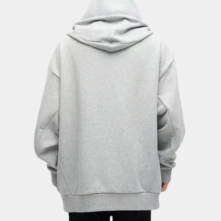 Grijze oversized hoodie, achterkant, uniseks, casual streetwear, comfortabele katoenen stof, minimalistisch design, mode voor dagelijks gebruik.