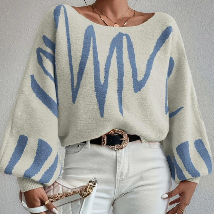 Damestrui met blauwe zigzagprint, wijde mouwen en ronde hals. Modieuze casual outfit, perfect voor herfst- en winterseizoenen.