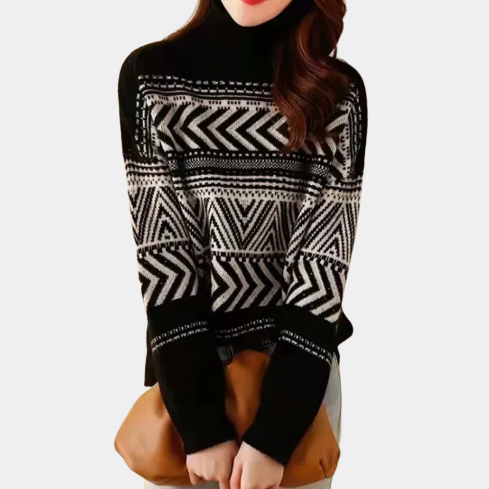 Zwart-witte damestrui met geometrisch zigzagpatroon, hoge hals en lange mouwen, gecombineerd met bruine handtas. Modieuze winterkleding.