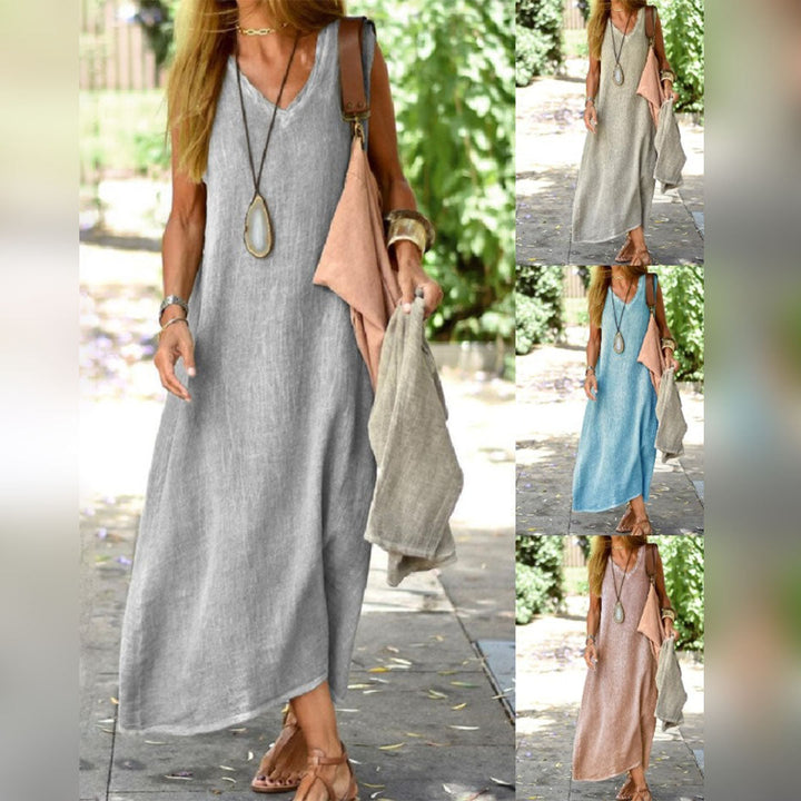 Vrouw in lange linnen zomerjurk met V-hals, verkrijgbaar in grijs, blauw, beige en roze. Ideaal voor casual en strandkleding. Comfortabel en stijlvol.