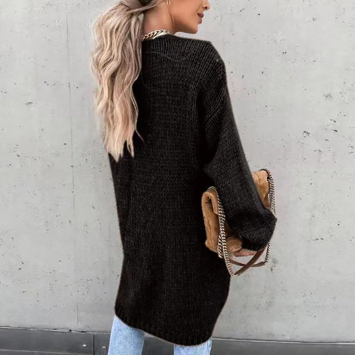 Vrouw in zwarte gebreide trui met lange mouwen, draagt een bruine tas met kettingriem, casual outfit, mode, herfstkleding, buitenmuur achtergrond.