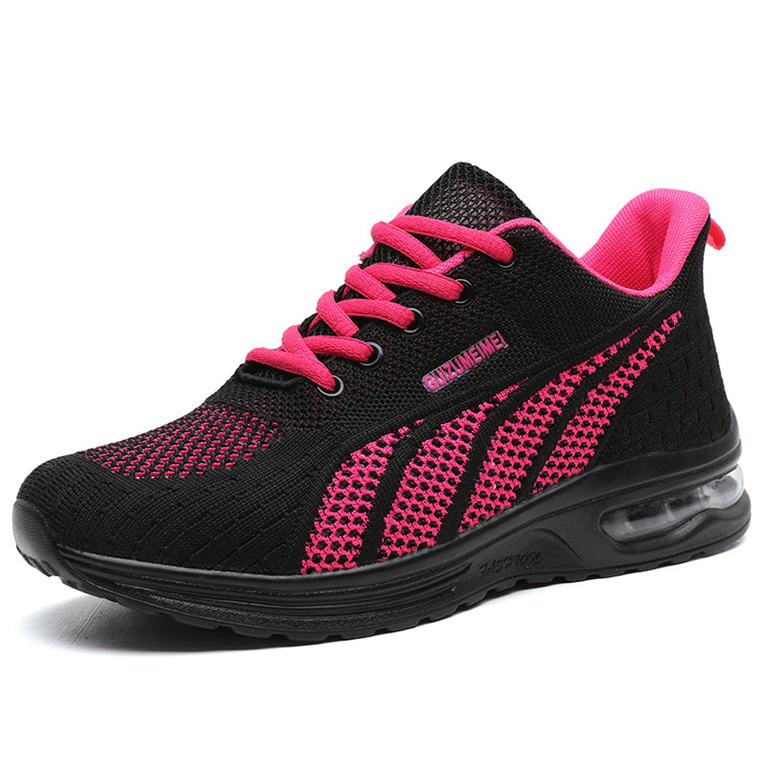 Zwarte sportschoen met roze accenten, ademend mesh bovenwerk, comfortabele zool, ideaal voor hardlopen en fitness. Unisex sneaker, trendy design.